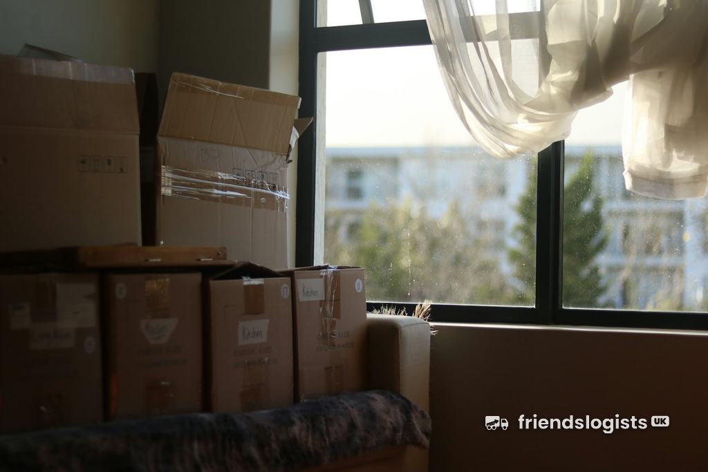 Packed boxes stacked by the window of a new home